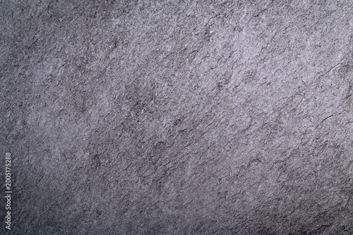 Photography Surface of a textured gray stone with layered patterns taken in natural light at