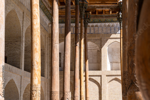 Detail of the carved and decorated wooden columns in Bukhara, Uzbekistan, on a summer day