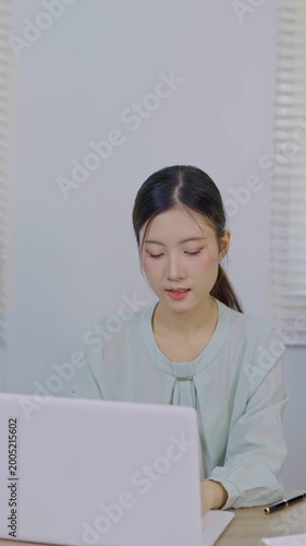 Asia beautiful business woman working with laptop in living room at office