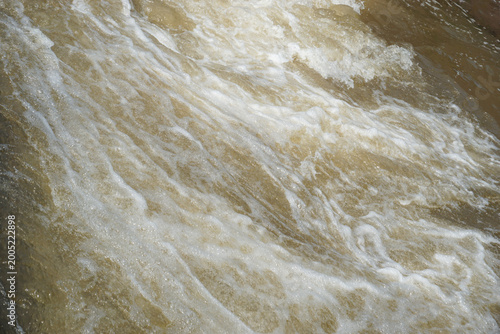 Photography The texture of the river water flow is fast, murky and has white foam in the rapids area