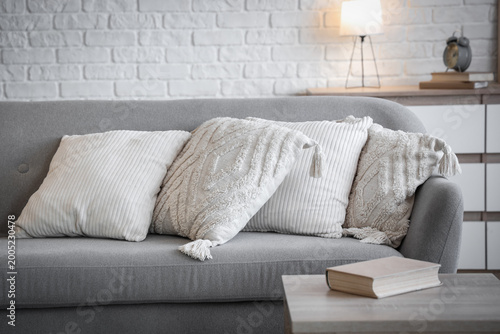 Cozy grey sofa with soft wh...
