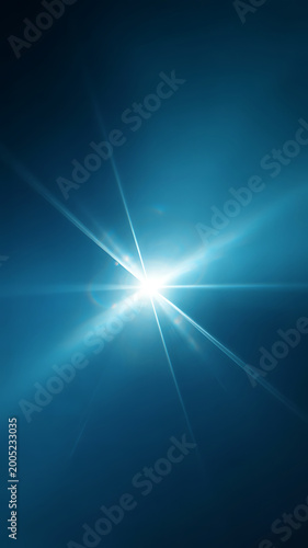 A bright light shining with rays on a blue background with a glowing effect and lens flare