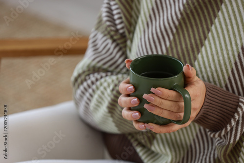 Young woman with cup of tea...