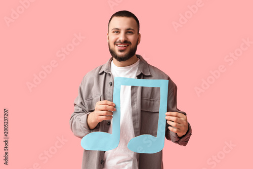 Young man with paper music ...
