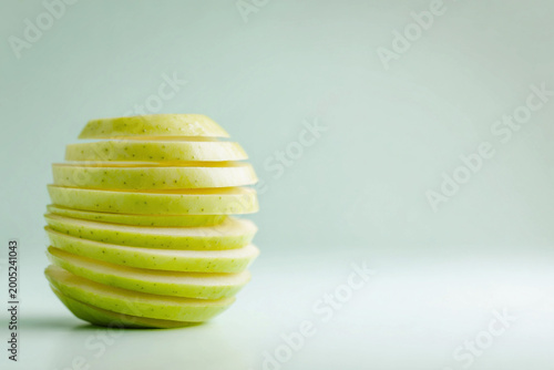 Green apple spiraled on a pastel backdrop with bright colors and clear design Generative AI