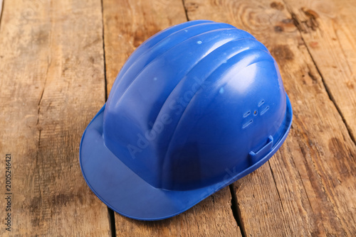 Blue hardhat on wooden back...