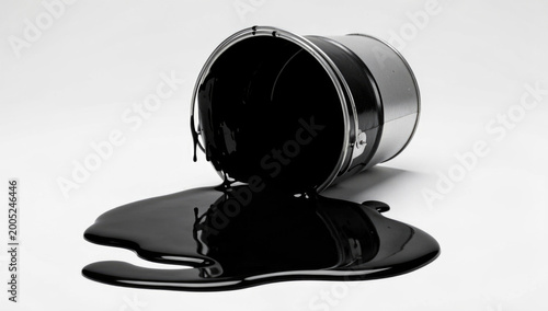 Black and white photo of a spilled bucket on the ground