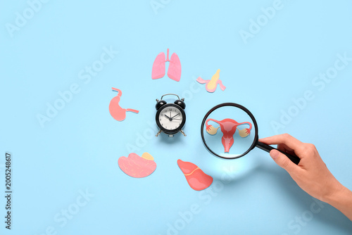 Female hand magnifying pape...