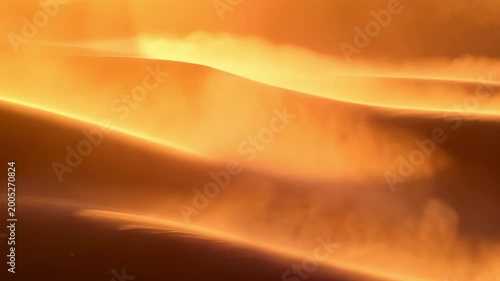 Slow motion tracking shot of sand dunes with wind blowing at sunset in desert