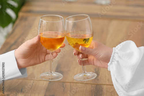 Female hands clinking glass...