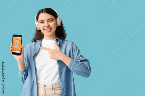Happy young woman in headph...