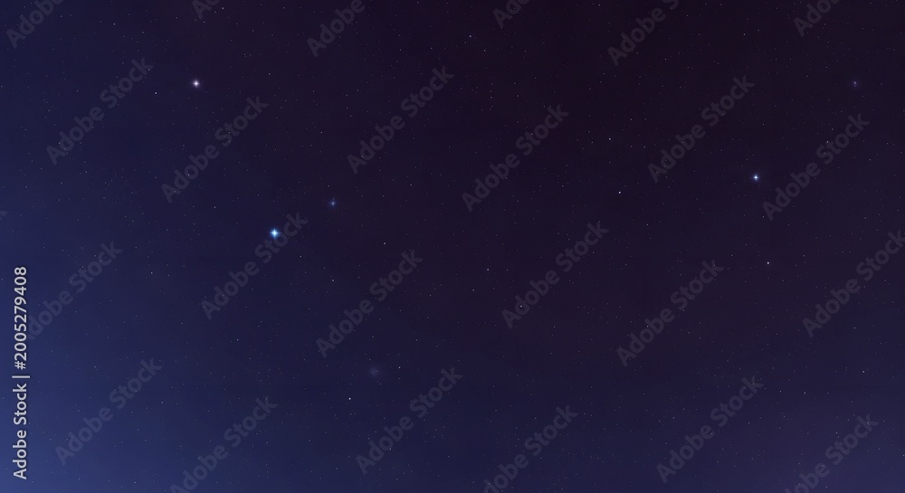 Obraz premium A clear night sky filled with countless twinkling stars and a faint nebula.