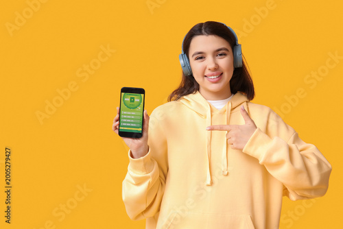 Happy young woman in headph...