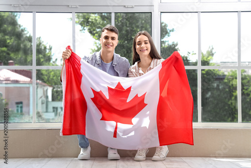 Young couple with flag of C...