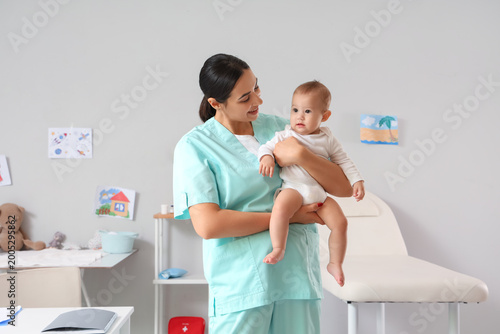 Female pediatrician with cu...