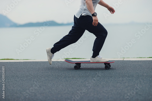 Skateboarder skateboarding at the seaside