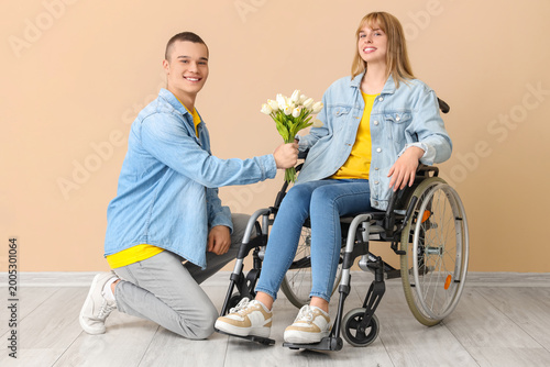 Teenage boy giving tulips t...
