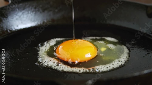 Golden yolk softly descends onto a hot skillet, beginning a magnificent breakfast transformation