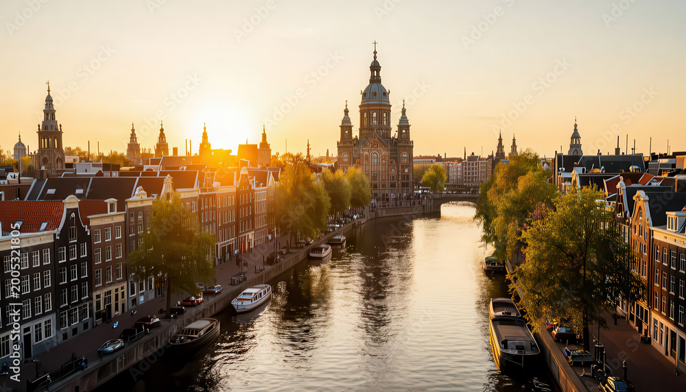 Fototapeta premium A sunset over a canal highlights the buildings in the city. The buildings along the canal reflect the warm sunlight, creating a serene scene by the water.