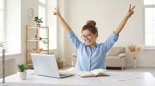 Excited office worker winner using laptop computer celebrating goal achievement. Happy young woman student or employee winning online getting good news in email raising hands feeling euphoric.