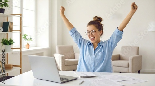 Excited office worker winner using laptop computer celebrating goal achievement. Happy young woman student or employee winning online getting good news in email raising hands feeling euphoric.