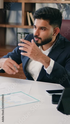 Two business multiracial colleagues discussing documents in office. Businessman and woman having a meeting in office. Two business colleagues discussing over a report document. Slow motion.