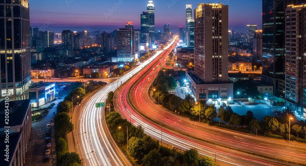Obraz premium Night time city skyline with bright lights and busy street