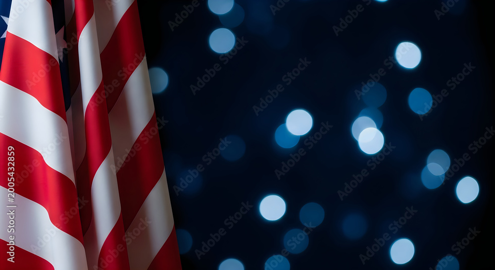 Fototapeta premium Close-up of American Flag with Bokeh Lights on Dark Background, Patriotic Symbol