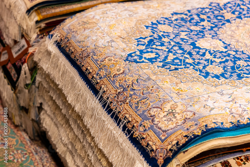Persian carpet stack blue floral pattern souk shop