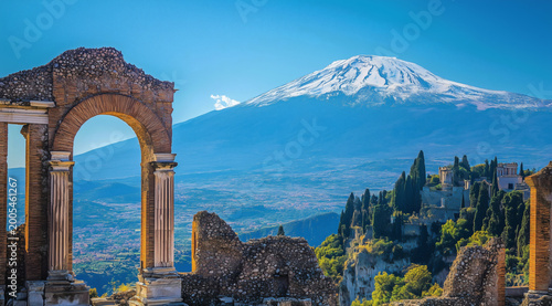 Ancient Roman ruins and white columns lead to Mount Etna, sunlight hits stones while clear sky and clouds fill the view.