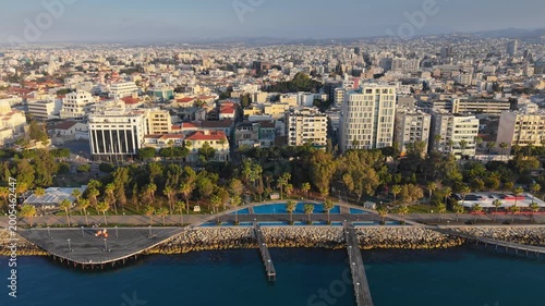 Aerial view of the beautiful Molos promenade in Limassol featuring palm trees and sea docks. Limassol waterfront with its unique wooden piers and palm alley, Cyprus