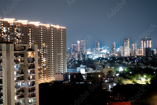 Layers of high rise buildings with small homes, parks and shops in between showing the mix of real estate in cities like gurgaon, noida, chandigarh, bangalore, chennai, pune