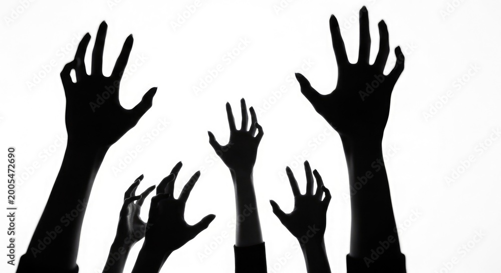 Fototapeta premium Reaching hands a dramatic silhouette of multiple arms extending upwards