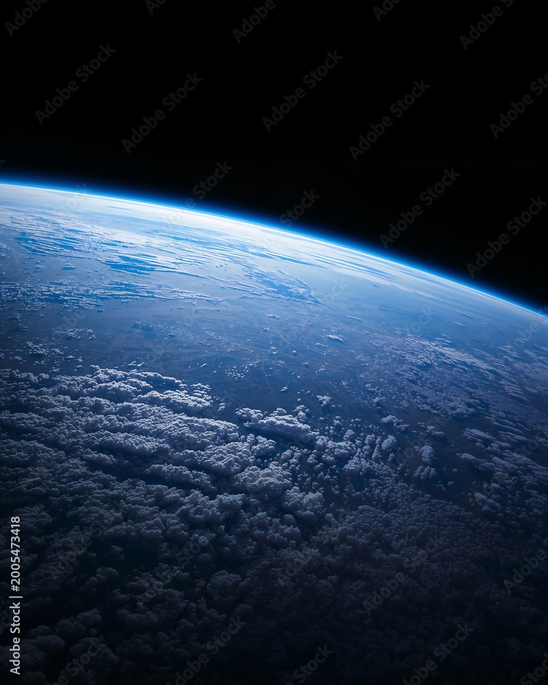 Fototapeta premium A mesmerizing view of Earth from space, showing the curvature, clouds, and atmosphere. The image evokes a sense of wonder and the vastness of the cosmos
