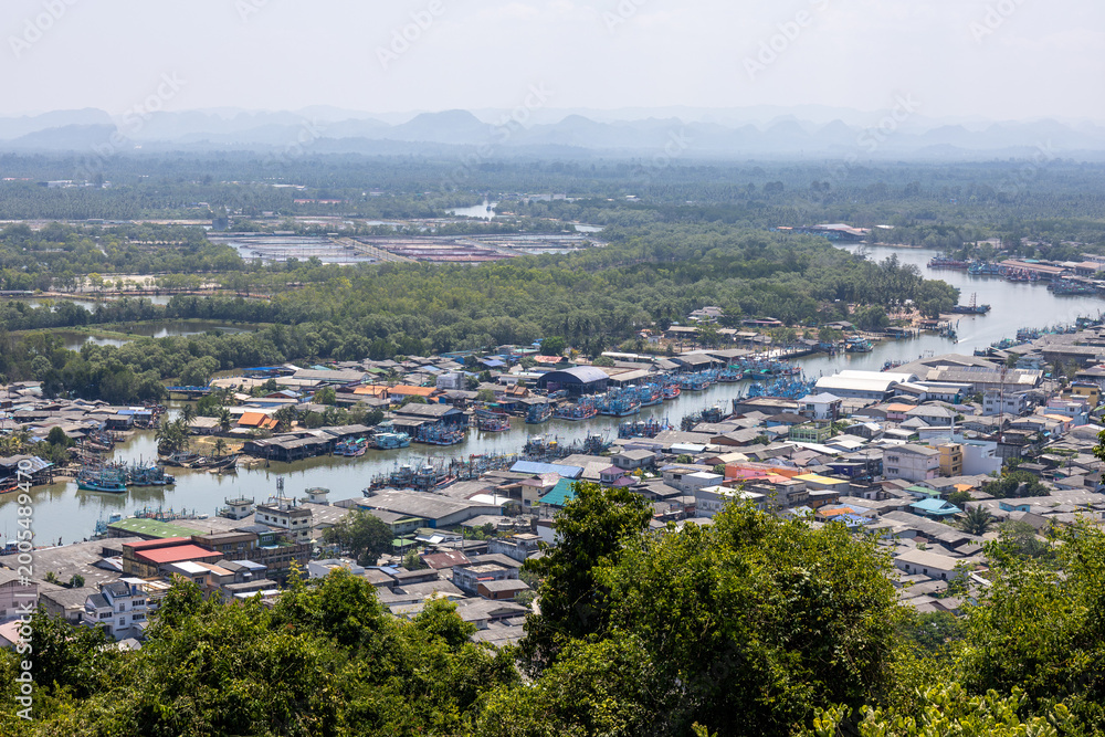 Obraz premium Peaceful scenic aerial view showing coastal town with river winding through beautiful village surrounded by green mountain landscape and calm natural environment