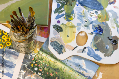 Obraz na płótnie Artist studio setup with brushes and palette, top view flat lay, creative worksp