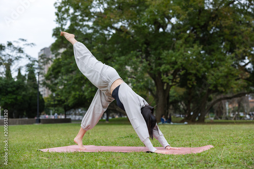 Fotografie Woman doing yoga in outdoor nature environment