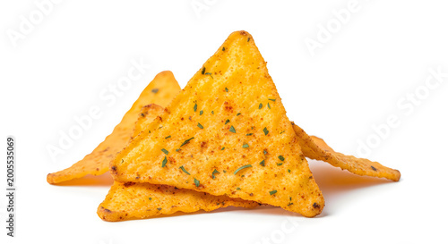 A stack of crispy triangular tortilla chips with herbs and spices on a white background