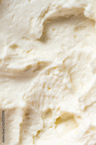 Photography Close-up of fluffy, white whipped cream or buttercream frosting with soft peaks and a smooth, creamy texture