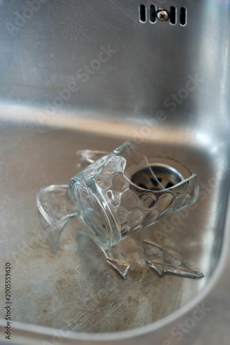 broken glass in a stainless steel sink