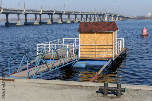 wooden pier on the beach overlooking the bridge