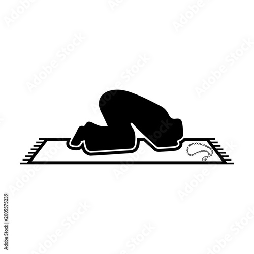 Muslim man praying on a rug with prayer beads