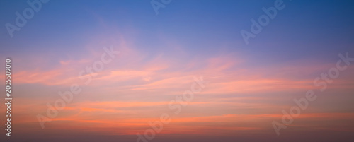Evening Sky Panoramic Background with Orange and Pink Soft Clouds on Blue Nature Sunset Sky, Colorful Tropical Sunrise Natural Backdrop