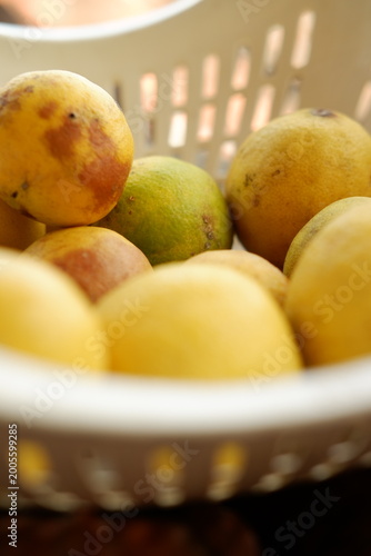 Photos Close up of Ripe Yellow Citrus Fruits Inside a Rustic Wicker Basket