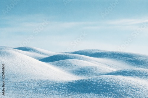 Minimal Snow Dunes Forming Abstract Winter Landscape Under Blue Sky