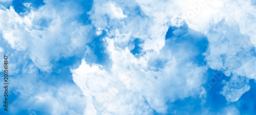 Valokuva Dense white cloud texture covering blue sky creating dramatic overcast atmosphere for weather backgrounds soft billowy vapor patterns filling frame with natural beauty and ethereal lighting effects