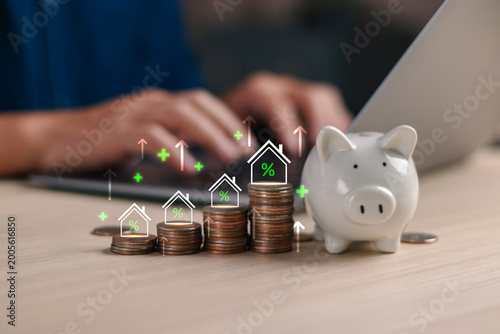 Foto Savings and Real estate investment concept with piggy bank and stacked coins, fe