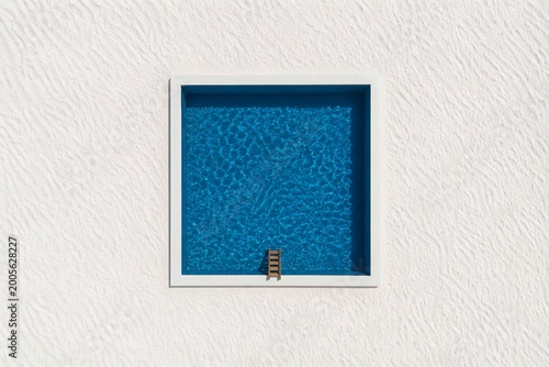 Minimalist Top View of Rectangular Swimming Pool with Ladder on White Sand Background