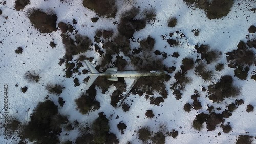 Stunning Aerial drone shot of an abandoned commercial airplane. Zooming out drone shot