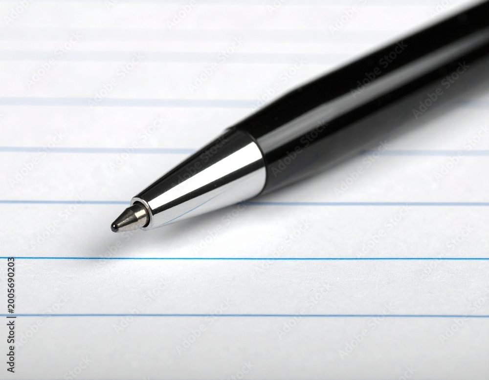 Naklejka premium Macro Shot of Executive Ballpoint Pen on Lined Paper, Business and Creative Writing Concept